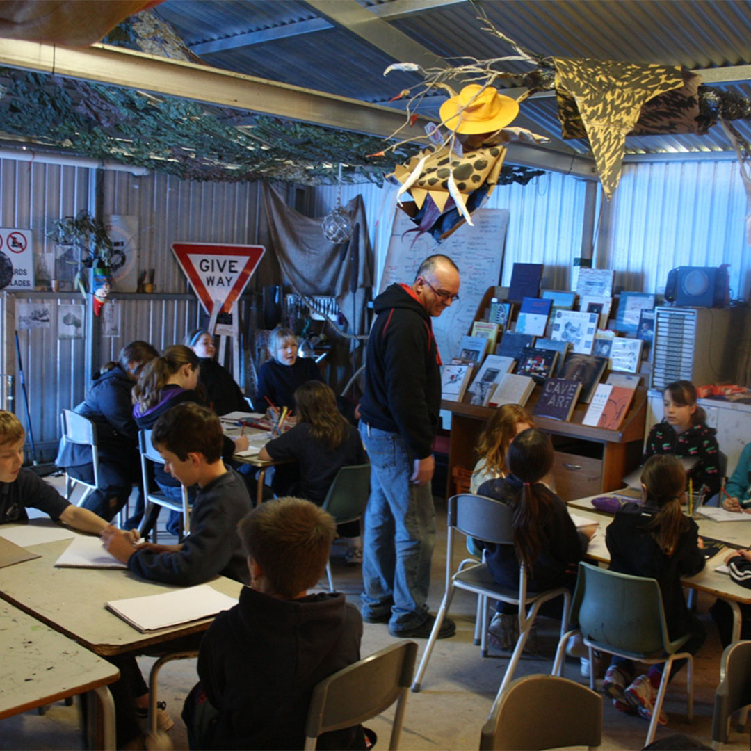 a group of children in a shed studio with a mentor
