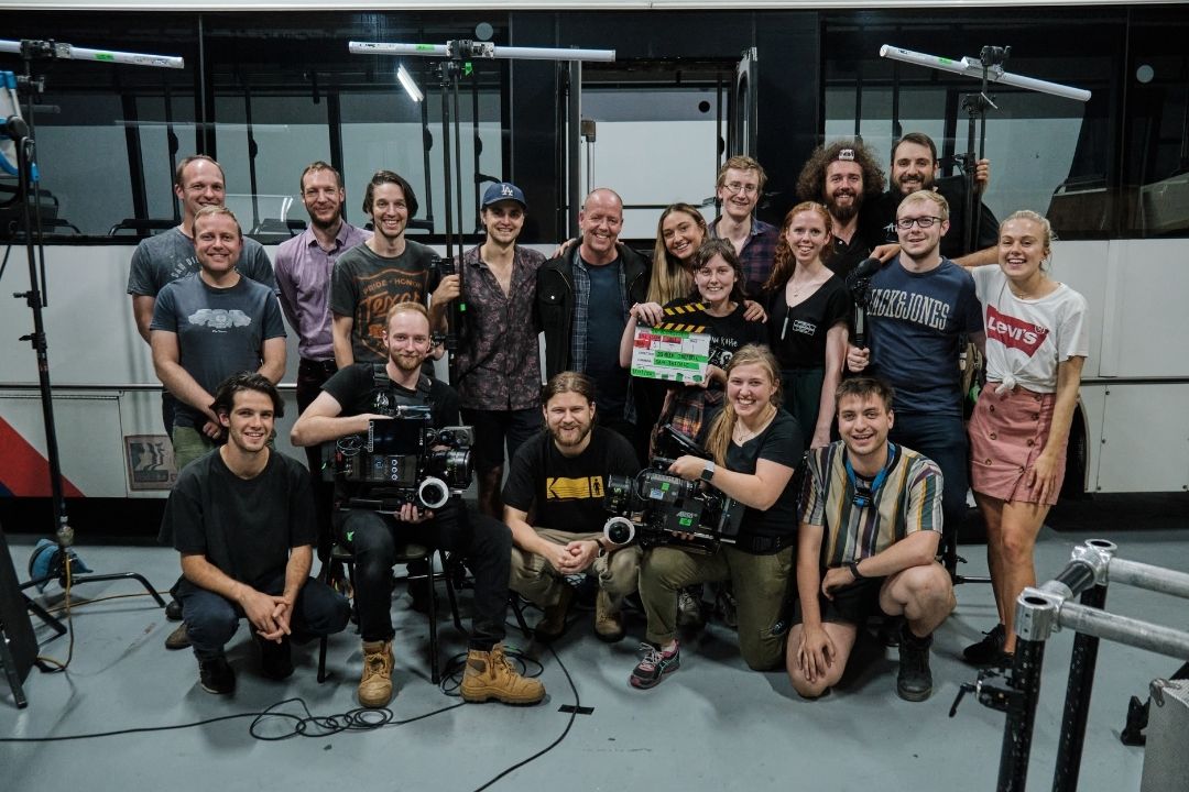 a film crew made kneeling and standing together